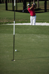 Image showing golfer hitting a sand bunker shot