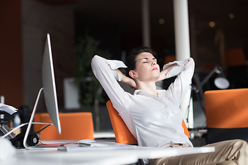 Image showing happy young business woman relaxing and geting insiration