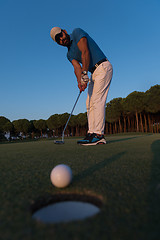 Image showing golfer  hitting shot at golf course