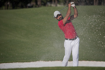 Image showing golfer hitting a sand bunker shot