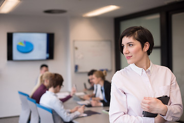 Image showing hispanic businesswoman with tablet at meeting room