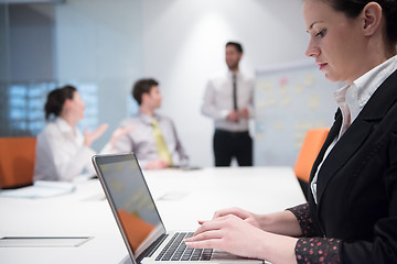 Image showing young business woman on meeting  using laptop computer