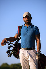 Image showing golfer  portrait at golf course on sunset