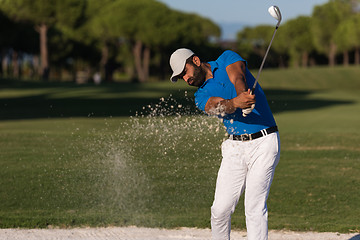 Image showing pro golfer hitting a sand bunker shot