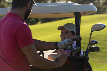 Image showing couple in buggy on golf course