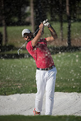 Image showing golfer hitting a sand bunker shot