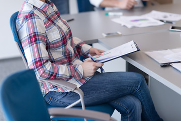 Image showing portrait of young business woman at office with team on meeting 