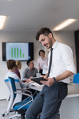 Image showing young business man with tablet at office meeting room