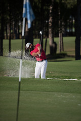 Image showing golfer hitting a sand bunker shot