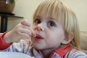 Image showing Young girl eating