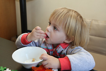 Image showing Young girl eating