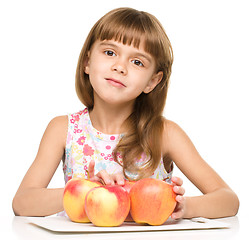 Image showing Little girl with red apples