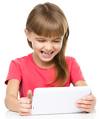 Image showing Young girl is using tablet