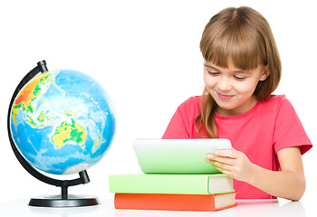 Image showing Young girl is using tablet