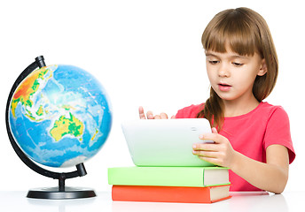 Image showing Young girl is using tablet