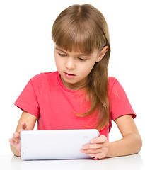 Image showing Young girl is using tablet