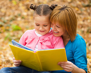 Image showing Mother is reading book with her daughter