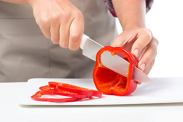 Image showing Cook is chopping bell pepper