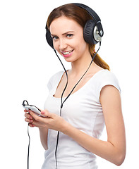 Image showing Young woman enjoying music using headphones