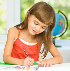 Image showing Little girl is drawing using pencils