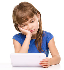 Image showing Young girl is using tablet