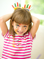 Image showing Portrait of a cute girl playing with paints