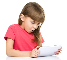 Image showing Young girl is using tablet