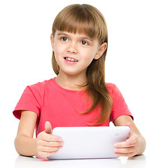 Image showing Young girl is using tablet