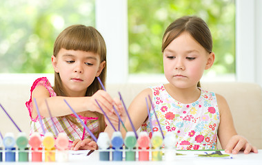 Image showing Little girls are painting with gouache