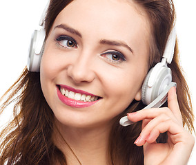 Image showing Lovely young woman is talking to customers