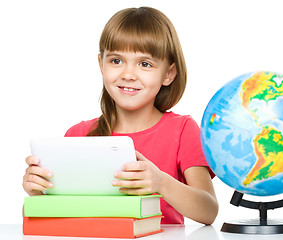 Image showing Young girl is using tablet