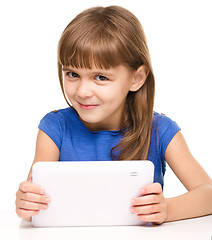 Image showing Young cheerful girl is using tablet