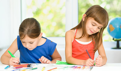 Image showing Little girls are drawing using pencils