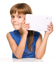 Image showing Young cheerful girl is using tablet