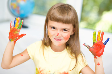 Image showing Portrait of a cute girl playing with paints