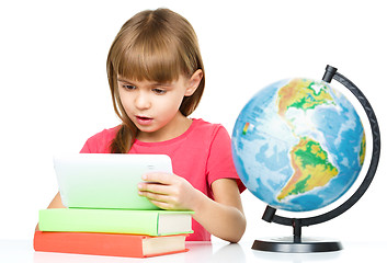 Image showing Young girl is using tablet