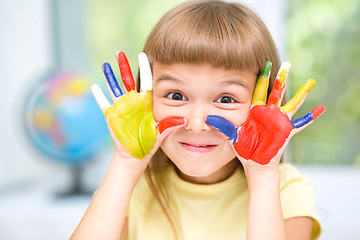 Image showing Portrait of a cute girl playing with paints