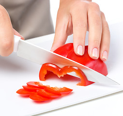 Image showing Cook is chopping bell pepper
