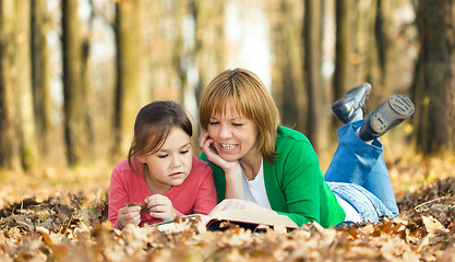 Image showing Mother is reading book with her daughter