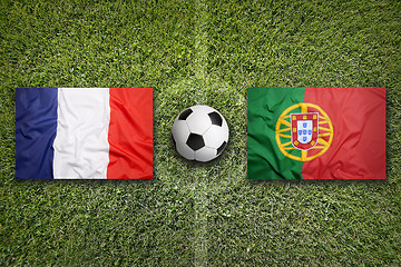 Image showing France vs. Portugal flags on soccer field