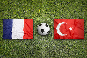 Image showing France vs. Turkey flags on soccer field