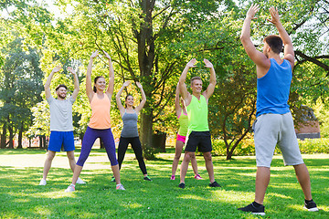 Image showing group of friends or sportsmen exercising outdoors