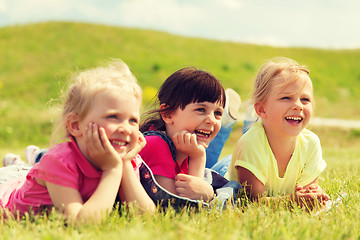 Image showing group of kids lying on blanket or cover outdoors