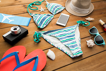 Image showing close up of smartphone and beach stuff