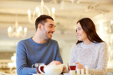 Image showing happy couple drinking tea at cafe