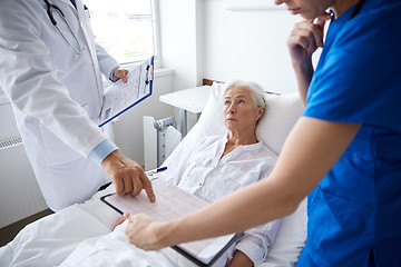 Image showing doctor and nurse visiting senior woman at hospital