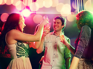 Image showing smiling friends with glasses of champagne in club