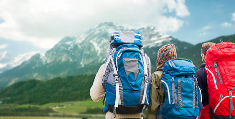 Image showing travelers with backpacks hiking in mountains