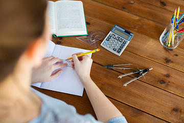 Image showing close up of hands with ruler and pencil drawing