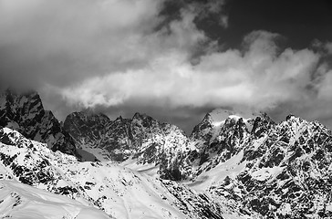 Image showing Black and white snowy rocks in clouds